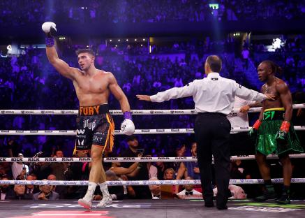 Tommy Fury celebrates winning a boxing match.
