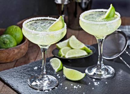 Pineapple jalapeÃ±o margaritas in martini glasses.