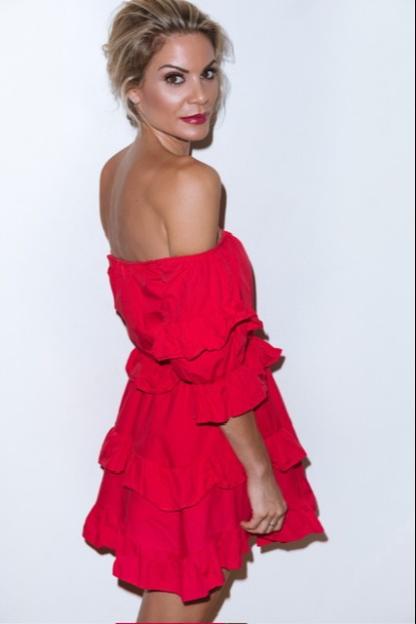 Woman in a red off-the-shoulder dress.