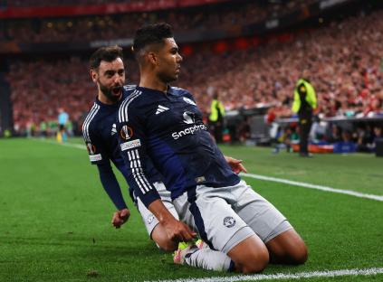 Casemiro of Manchester United celebrates a goal with a teammate.