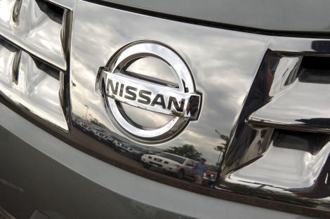 Close-up of a Nissan Murano emblem on a vehicle's grill.