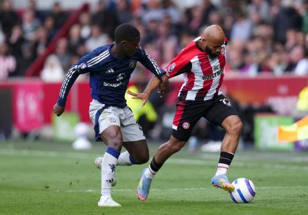 Manchester United's Kobbie Mainoo and Brentford's Bryan Mbeumo battling for the ball during a Premier League match.