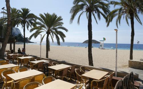 People walk by an empty terrace bar at Magaluf beach in Mallorca as British tourists are expected to resume travels to the area starting from June 30th, Spain, June 29, 2021. REUTERS/Enrique Calvo