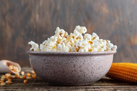 Bowl of popcorn with corn on the cob.