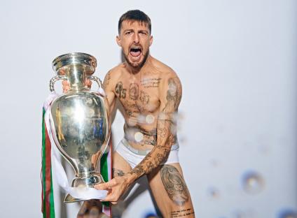 Francesco Acerbi holding the Henri Delaunay Trophy.