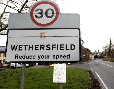 Wethersfield village sign: 30 mph speed limit. Reduce your speed. Neighbourhood Watch area.