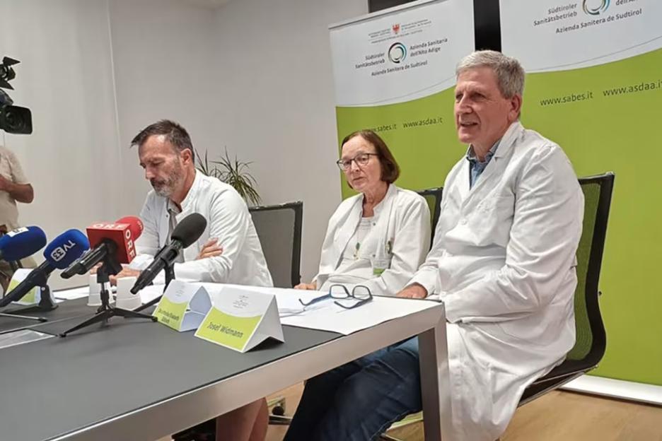 Three doctors at a press conference.