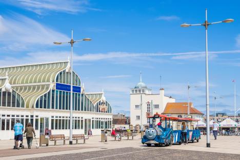 people walking in front of a building with a sign that says ocean park