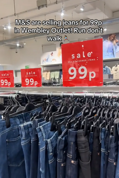 Rows of jeans for sale at 99p in a store.