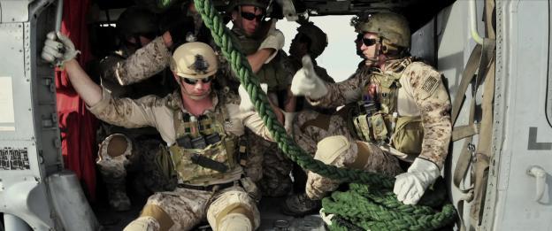Soldiers in a helicopter during a mission.