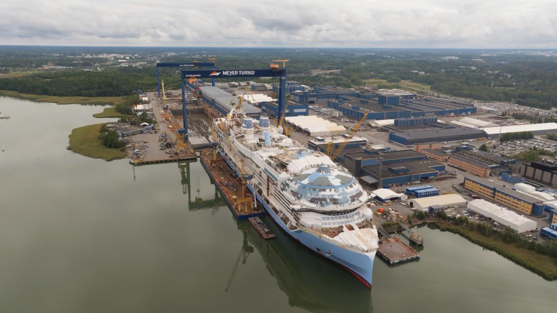 Aerial view of the Legend of the Seas cruise ship under construction in a shipyard.