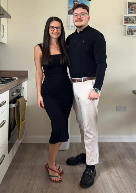 Georgia and Laurence posing together in a kitchen.