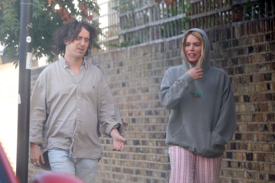 Billie Piper and Johnny Lloyd walking down the street.