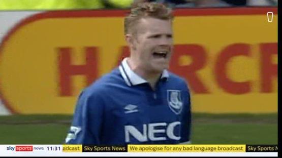 A soccer player in a blue jersey with