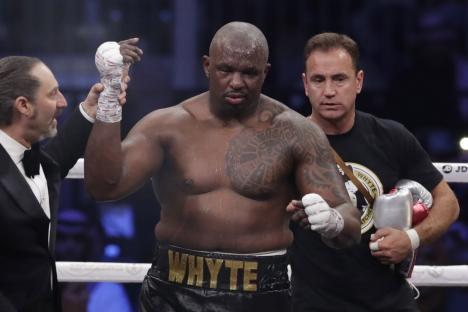 FILE - Dillian Whyte of Britain celebrates winning a heavyweight undercard boxing match against Mariusz Wach of Poland at the Diriyah Arena, in Riyadh, Saudi Arabia, Saturday, Dec. 7, 2019. Dillian Whyte's heavyweight rematch against Anthony Joshua was canceled after Whyte returned adverse analytical findings on a doping test, Matchroom Boxing said Saturday. The bout had been scheduled for Aug. 12 at Londons O2 Arena.(AP Photo/Hassan Ammar, File)
