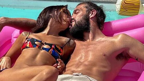 Loved-up Andy Carroll kisses girlfriend Lou Teasdale on an inflatable after confirming wedding plans