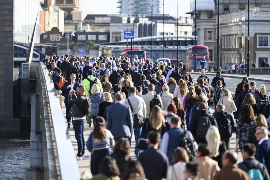 Large crowd of people commuting to work in London, England.