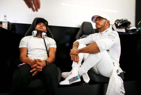 Lewis Hamilton and his brother Nicolas Hamilton sitting together.