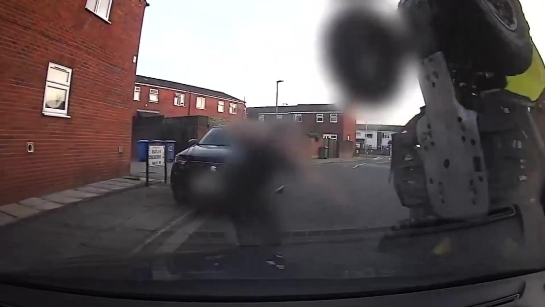 Video grab of a quad bike flipping over a police car.