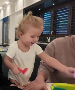Toddler playing with a toy.