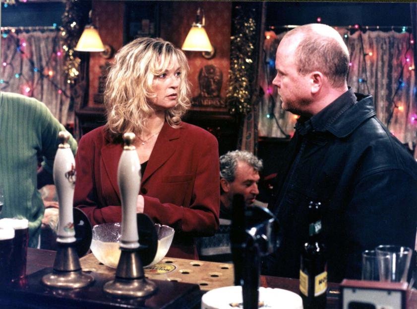 Still image from EastEnders: Phil and Kathy arguing in a pub.