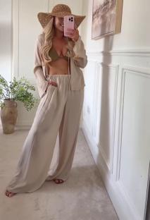 Woman modeling beige wide-leg pants and matching top.