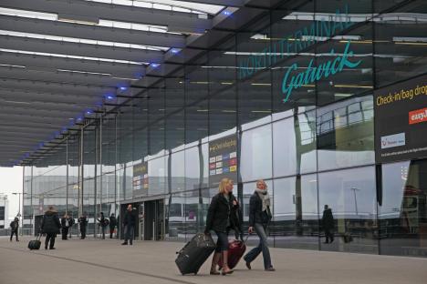 Passengers with luggage at Gatwick Airport's North Terminal.