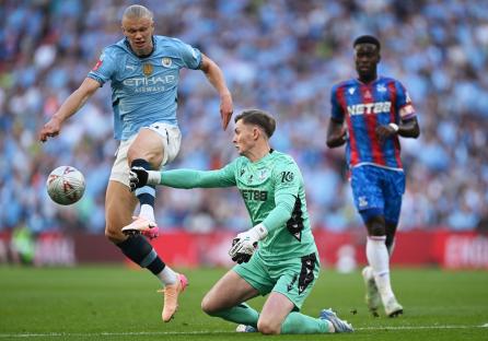 Dean Henderson of Crystal Palace making a save during a soccer match.