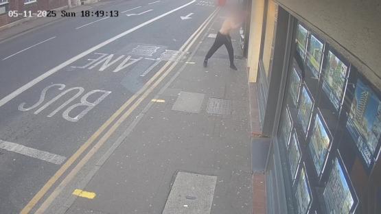 Security camera footage of a man smashing windows with a fire extinguisher.