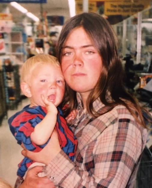 Photo of a young woman holding a baby.