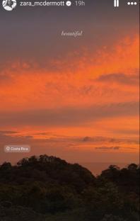 Orange sunset over trees in Costa Rica.