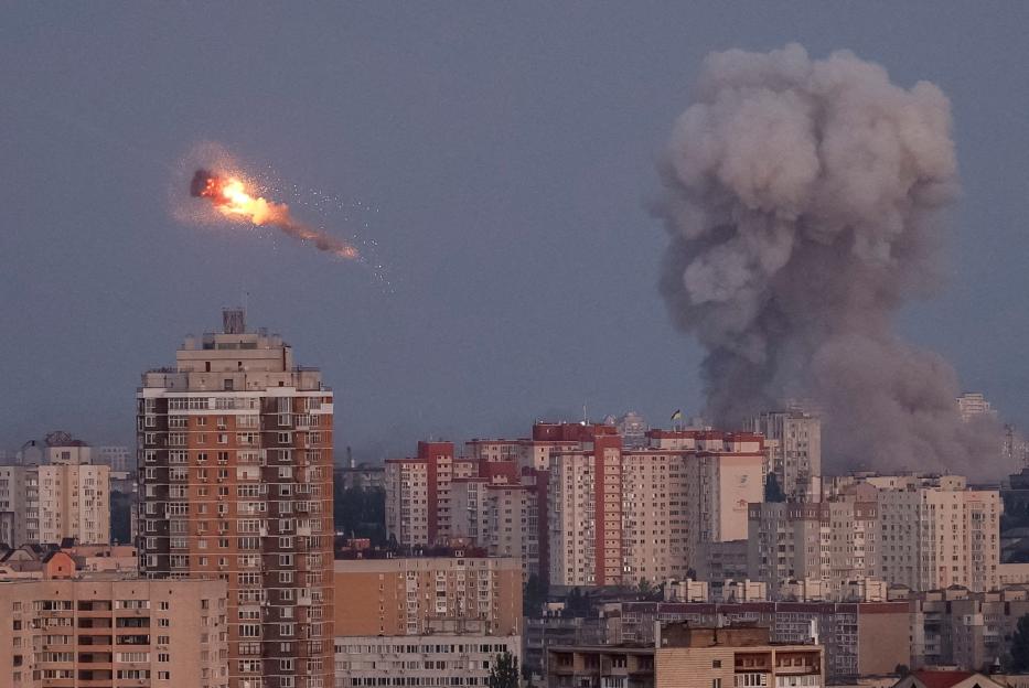 Ukrainian servicemen shooting down a Russian missile over Kyiv.
