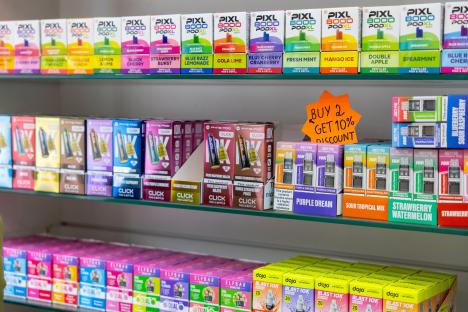 Shop shelves stocked with various vape products.