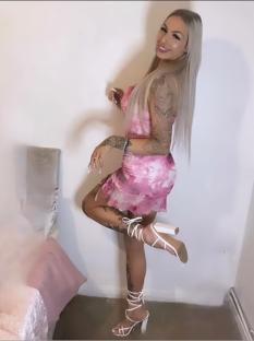 Woman in pink dress and white heels.