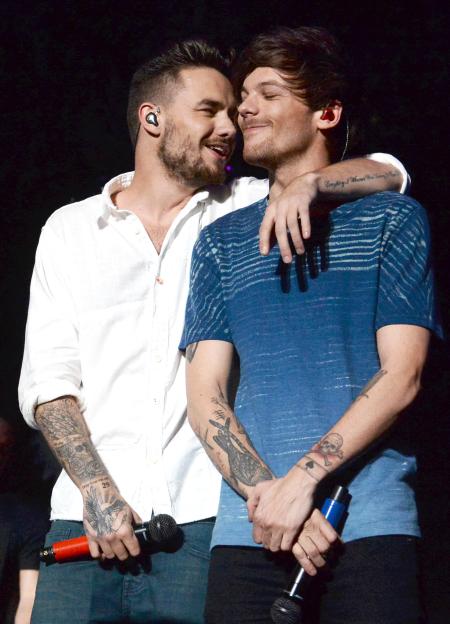 Recording artist Liam Payne and Louis Tomlinson of One Direction performing onstage.