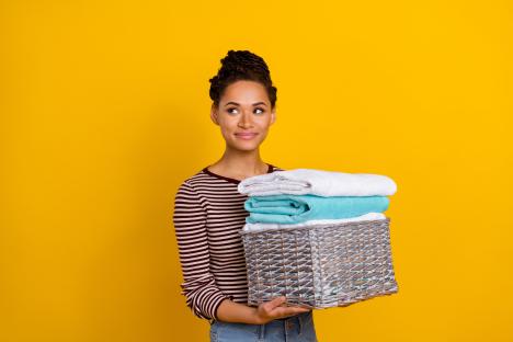 Woman holding a basket of towels.