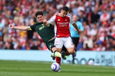 LONDON, ENGLAND - APRIL 12: Christian Norgaard of Brentford receives a yellow card for this challenge on Gabriel Martinelli of Arsenal during the Premier League match between Arsenal FC and Brentford FC at Emirates Stadium on April 12, 2025 in London, England. (Photo by Marc Atkins/Getty Images)