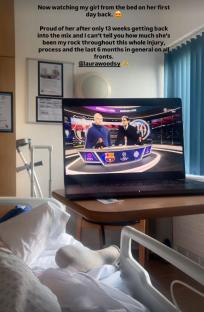 Person in hospital bed watching sports on laptop.
