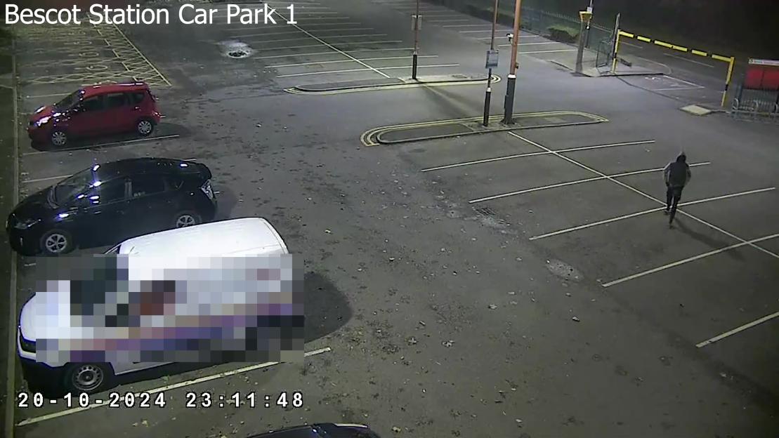 CPS footage of Deng Cholmajek walking through a parking lot at night.