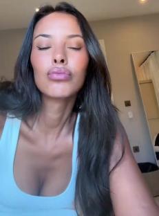 Maya Jama in a light blue tank top.