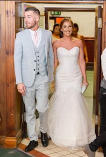 A bride and groom walking down an aisle.