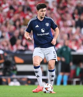 Harry Maguire of Manchester United controlling the ball during a soccer match.