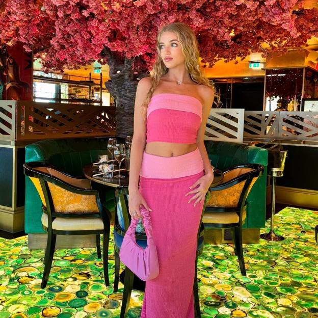 Princess Andre in a pink two-piece outfit.