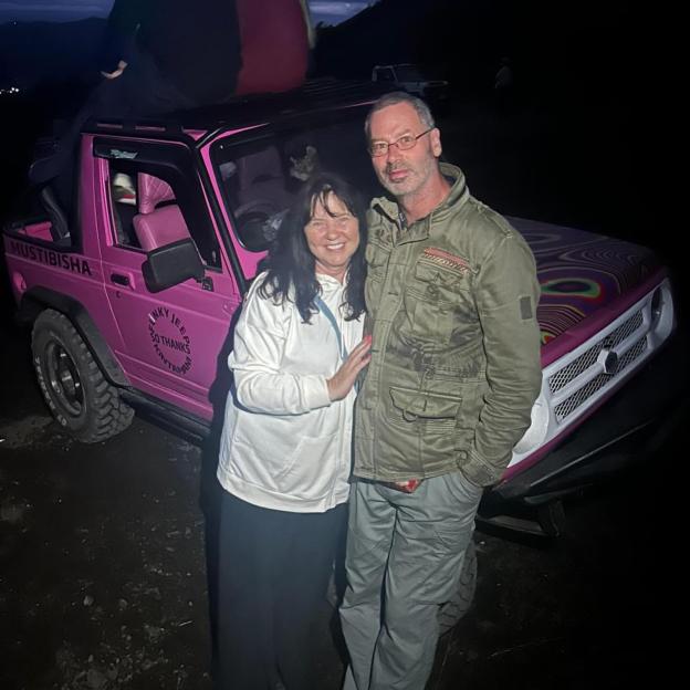 Coleen Nolan and her boyfriend Michael pose next to a pink jeep.