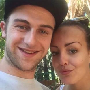Photo of a man and woman smiling for a selfie.