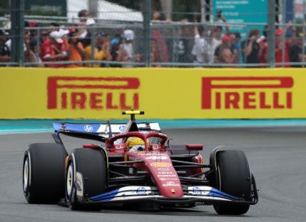 Formula 1 race car on track with spectators in the background.