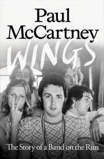 Book cover: Paul McCartney Wings, The Story of a Band on the Run. Black and white photo of Paul McCartney and the Wings band.