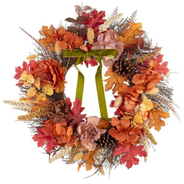 Autumnal wreath with orange and brown flowers and leaves, accented with pine cones and a green velvet ribbon.