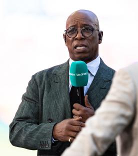 Ian Wright speaking into a microphone.