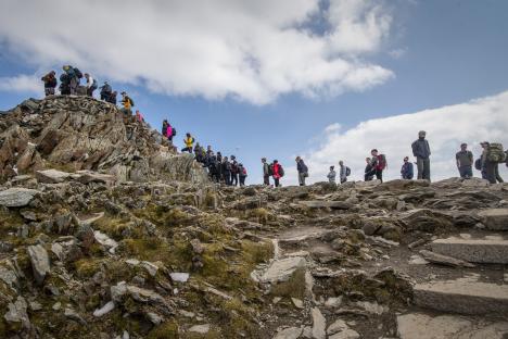 Hikers on the rocky summit of Mount Snowdon.